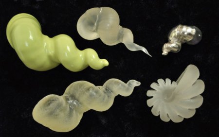 Five 3D printed pale yellow shell-like objects
