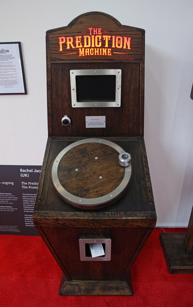 Photo of The Prediction Machine - awooden-style arcade-like machine with large dial and screen