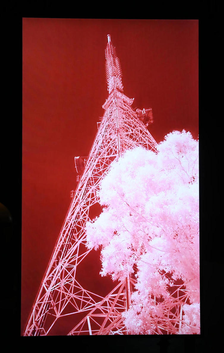 image of pylon-like communications tower inverted white out of red